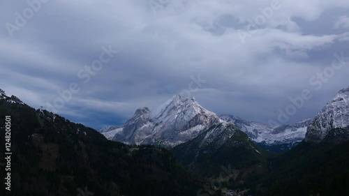 Slow aerial footage of Piccolo Vernel, mountain in the Marmolada Range of the Dolomites in Italy on a stormy day. photo