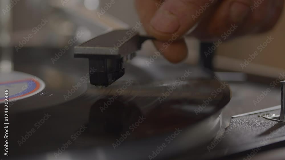 close-up shot of a vinyl record player in action. The focus is on the record player's needle making contact with the spinning vinyl record. close-up shot of a vinyl record player in action. The focus is on the record player's needle making contact with the spinning vinyl record.
