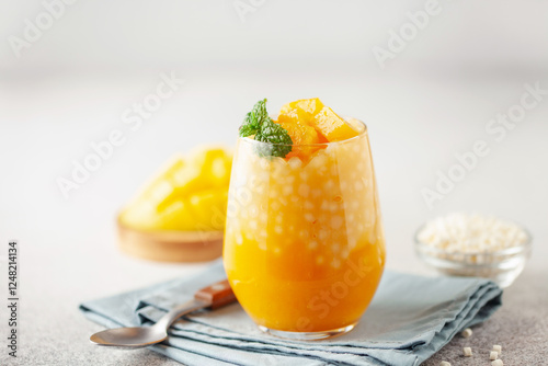 Tableau sur toile Mango sago creamy dessert in a glass on a white background