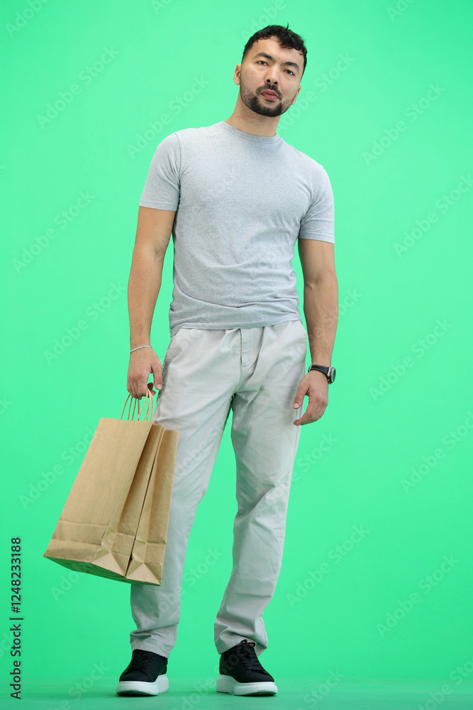 Man, on a green background, full-length, with bags Man, on a green background, full-length, with bags