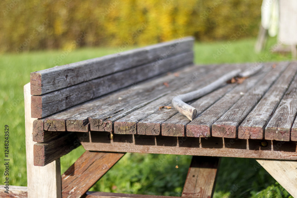 Naklejka premium old wooden table with chairs located in the garden.