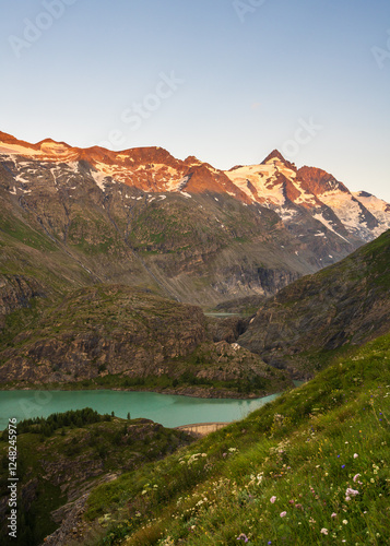 Glacial turquoise Lake Sandersee near Austrias highest mountain Grossglockner with snowy peaks. Carinthia. Austria photo