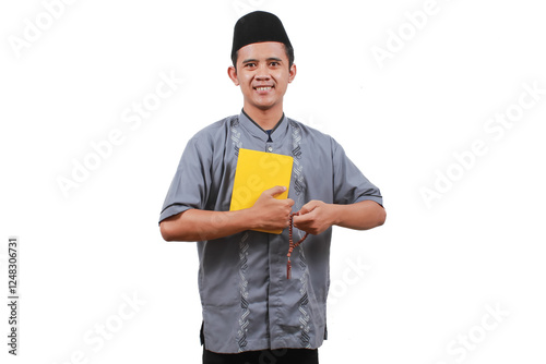 asian muslim man carrying book and prayer beads smiling expression isolated on white background photo