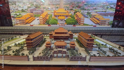 A detailed scale model of Wat Boromracha Kanchanaphisek, the temple's layout and architectural design, orbit photo