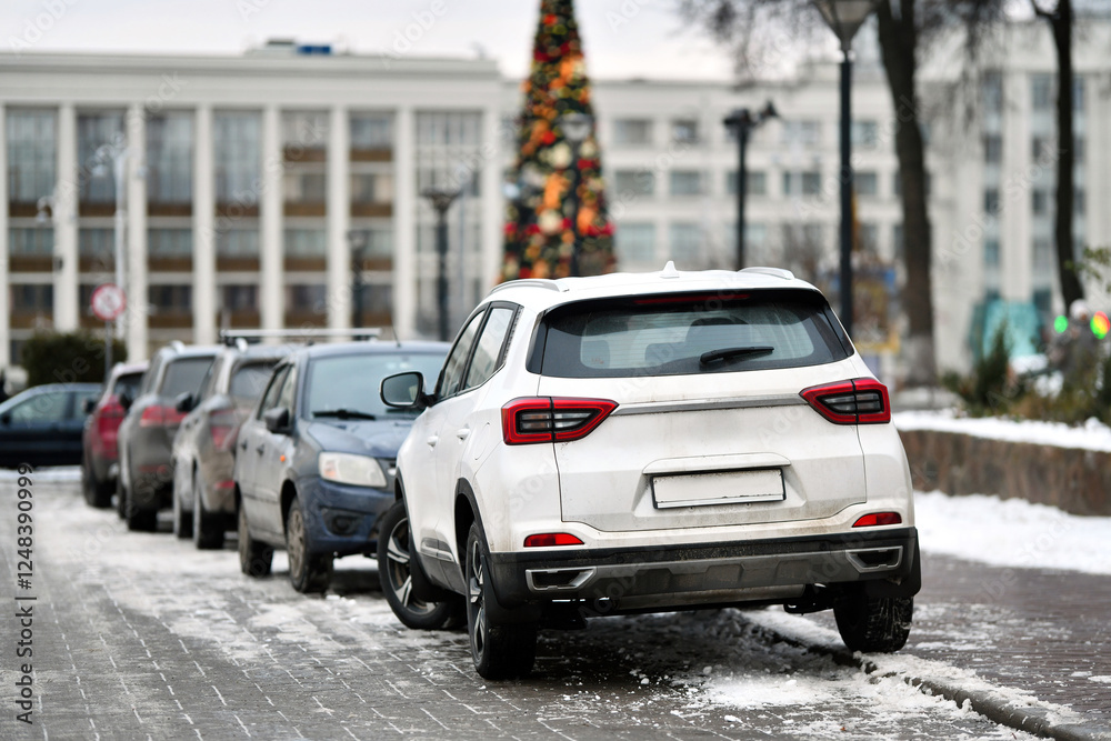 Downtown parking with row of cars tightly lined up in limited spaces, challenges of urban congestion and the struggle for available spots in the city center.