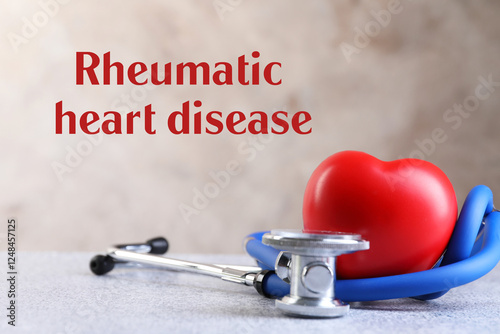 Rheumatism. Stethoscope, red heart and words Rheumatic Heart Disease on blurred background