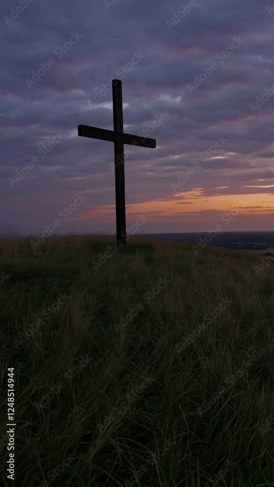A serene video still of a cross on a hill at sunset, captured from a low angle, emphasizing the dramatic sky and tranquil landscape. A serene video still of a cross on a hill at sunset, captured from a low angle, emphasizing the dramatic sky and tranquil landscape.
