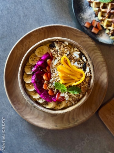 Smoothie bowl with bananas, berries, granola and other ingredients
