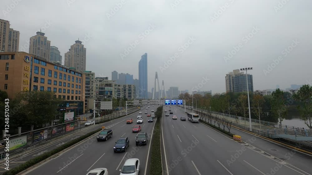 Overcast traffic time lapse on Wuhan Jiangcheng Avenue showcasing urban life and movement Overcast traffic time lapse on Wuhan Jiangcheng Avenue showcasing urban life and movement