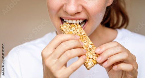 Woman eating protein bar. Healthy diet.