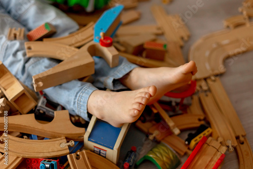 Wallpaper Mural Child, cute boy, playing with toys in a playroom, focus on his feet Torontodigital.ca