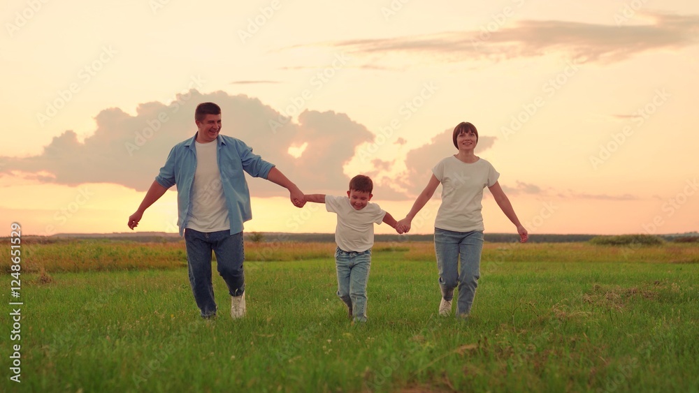 Family, Kid, run on green grass in meadow. Mother, father, child dream together in park at sunset. Happy family, child, walk through summer field, holding hands. Mom dad son walks together in nature Family, Kid, run on green grass in meadow. Mother, father, child dream together in park at sunset. Happy family, child, walk through summer field, holding hands. Mom dad son walks together in nature