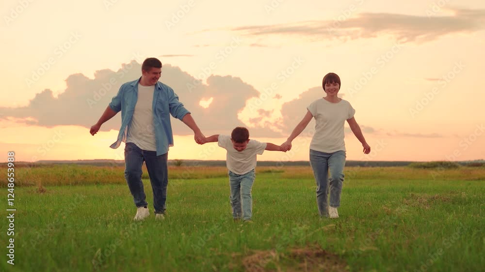 Family, Kid, run on green grass in meadow. Mother, father, child dream together in park at sunset. Happy family, child, walk through summer field, holding hands. Mom dad son walks together in nature Family, Kid, run on green grass in meadow. Mother, father, child dream together in park at sunset. Happy family, child, walk through summer field, holding hands. Mom dad son walks together in nature