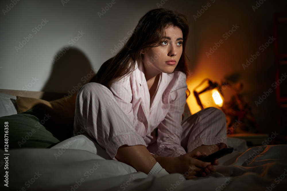 Fototapeta premium Struggling with thoughts while sitting alone in dim lighting at home