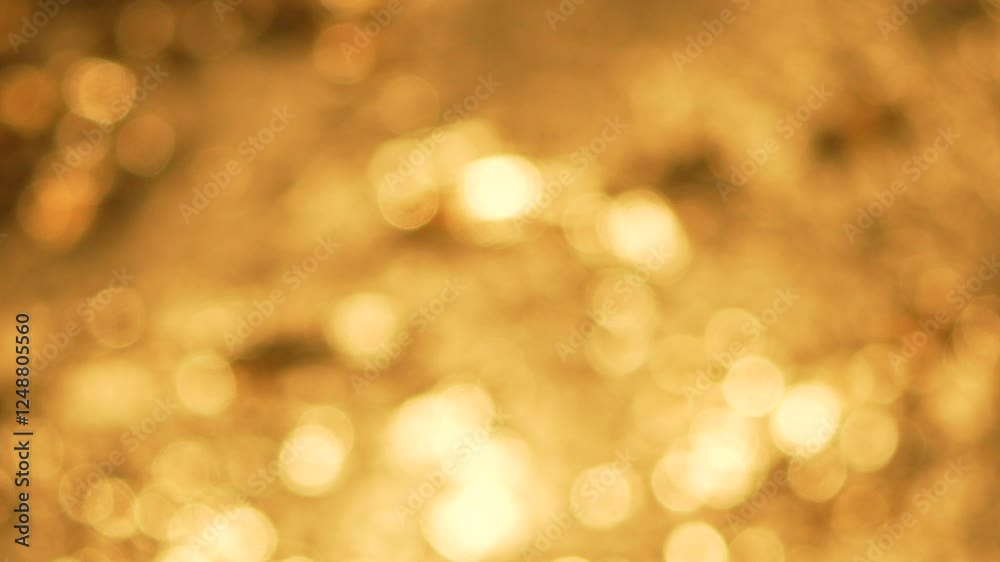 Water Sunlight Reflections Abstract Blurred Background. Abstract close-up of shimmering water with golden light reflecting off the surface. The water is out of focus, creating a bokeh effect. Water Sunlight Reflections Abstract Blurred Background. Abstract close-up of shimmering water with golden light reflecting off the surface. The water is out of focus, creating a bokeh effect.