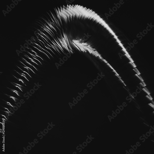 Abstract of metal coiled slinky, length of fine wire wound around and stretched, against a black background