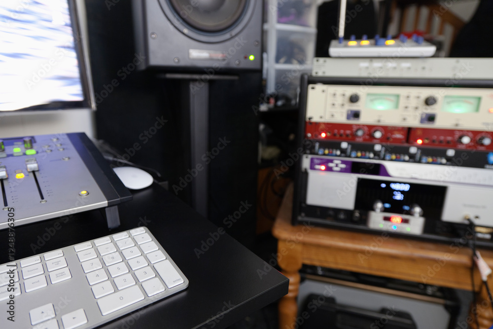 A computer workstation with sound board, speakers, headphones, recording deck and amplifier in a home recording studio A computer workstation with sound board, speakers, headphones, recording deck and amplifier in a home recording studio
