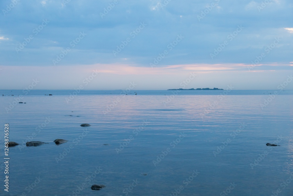Obraz premium blue, clear water and sky during sunset