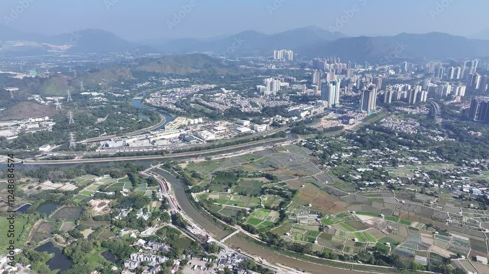 Explore the aerial view of urban development in Fanling Sheung Shui near Lo Wu Hong Kong Shenzhen, where large tracts of farmland are being redeveloped into residential housing to address population Explore the aerial view of urban development in Fanling Sheung Shui near Lo Wu Hong Kong Shenzhen, where large tracts of farmland are being redeveloped into residential housing to address population