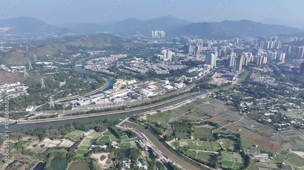 Explore the aerial view of urban development in Fanling Sheung Shui near Lo Wu Hong Kong Shenzhen, where large tracts of farmland are being redeveloped into residential housing to address population Explore the aerial view of urban development in Fanling Sheung Shui near Lo Wu Hong Kong Shenzhen, where large tracts of farmland are being redeveloped into residential housing to address population