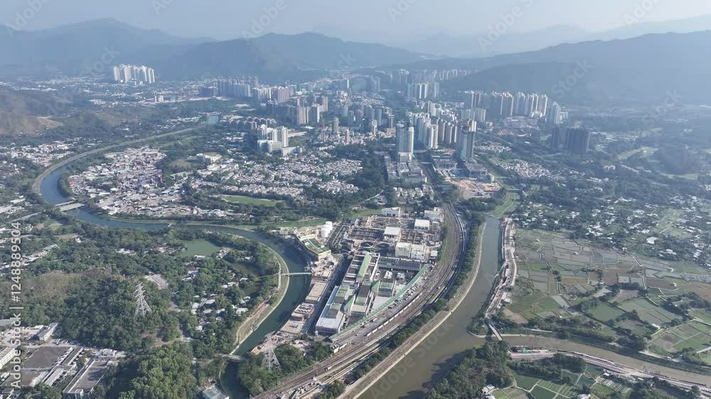 Explore the aerial view of urban development in Fanling Sheung Shui near Lo Wu Hong Kong Shenzhen, where large tracts of farmland are being redeveloped into residential housing to address population Explore the aerial view of urban development in Fanling Sheung Shui near Lo Wu Hong Kong Shenzhen, where large tracts of farmland are being redeveloped into residential housing to address population