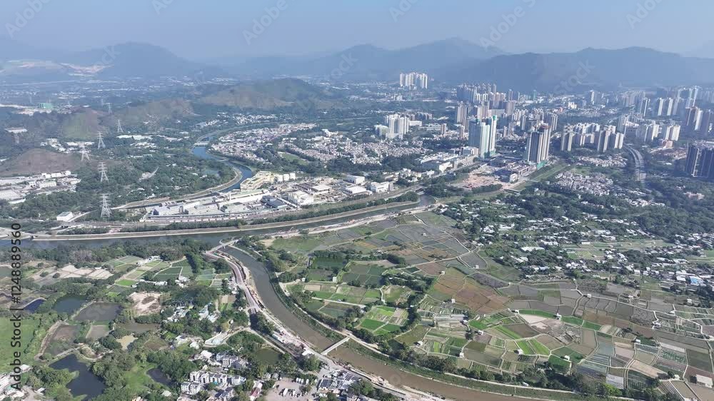Explore the aerial view of urban development in Fanling Sheung Shui near Lo Wu Hong Kong Shenzhen, where large tracts of farmland are being redeveloped into residential housing to address population Explore the aerial view of urban development in Fanling Sheung Shui near Lo Wu Hong Kong Shenzhen, where large tracts of farmland are being redeveloped into residential housing to address population