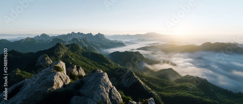A breathtaking sunrise over sprawling misty mountains, capturing an expansive view of nature awakening in soft, enveloping light.