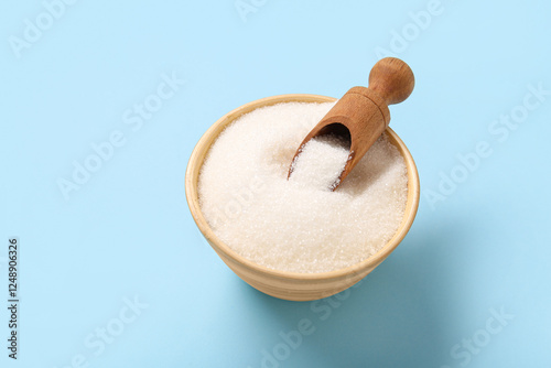 Bowl with white sugar on bl...