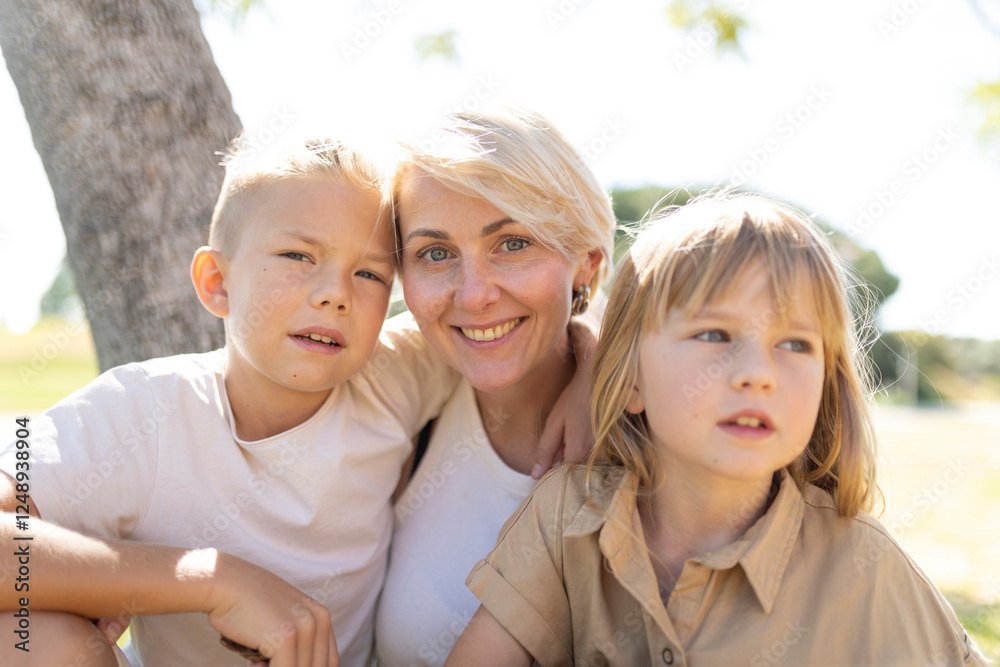 Fototapeta premium Happy mother and children enjoying outdoor time