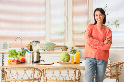 Young woman with blender an...