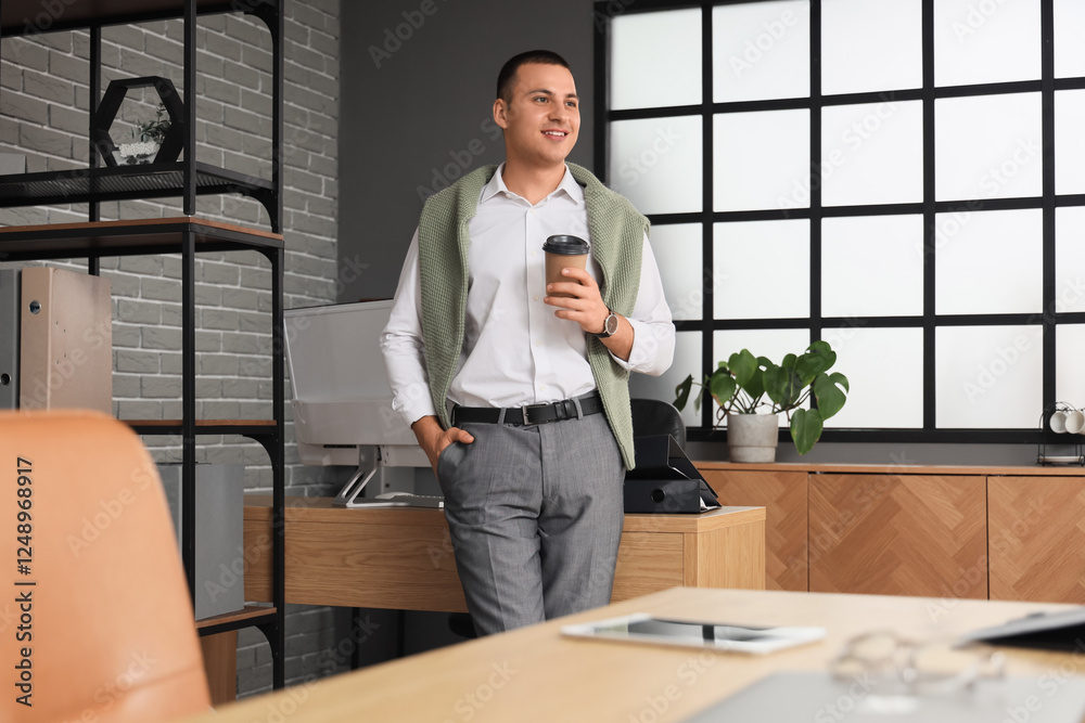 Handsome businessman with cup of coffee in office Handsome businessman with cup of coffee in office