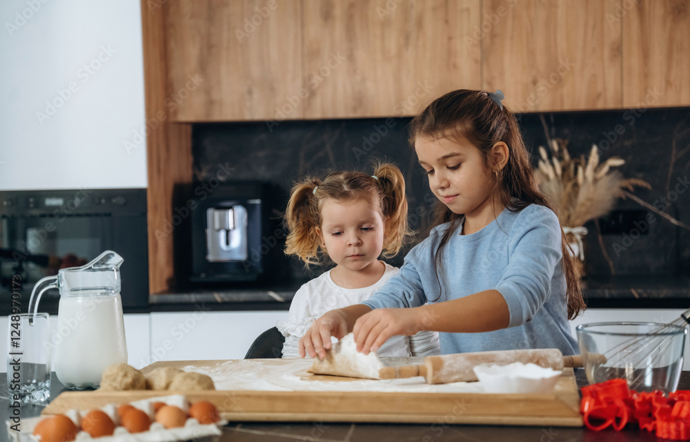 Dough work. Two little girls are preparing bakery at home Dough work. Two little girls are preparing bakery at home