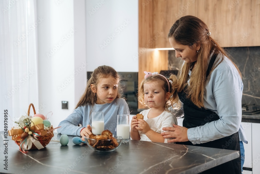 Woman is in apron. Mother with her little daughters preparing bakery Woman is in apron. Mother with her little daughters preparing bakery