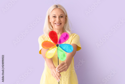 Mature woman with toy windm...