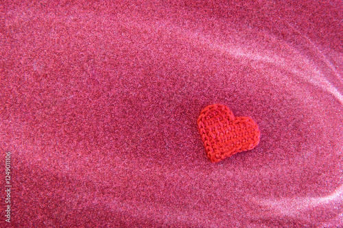 Colorful heart shaped decoration on a sparkling pink background for celebrations or crafts photo