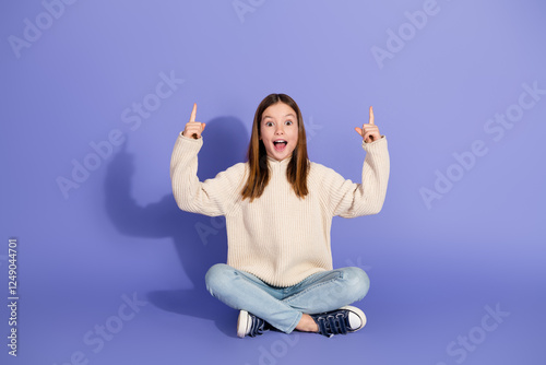Fotografija Young girl in casual fashion style posing happily against a purple backdrop in a