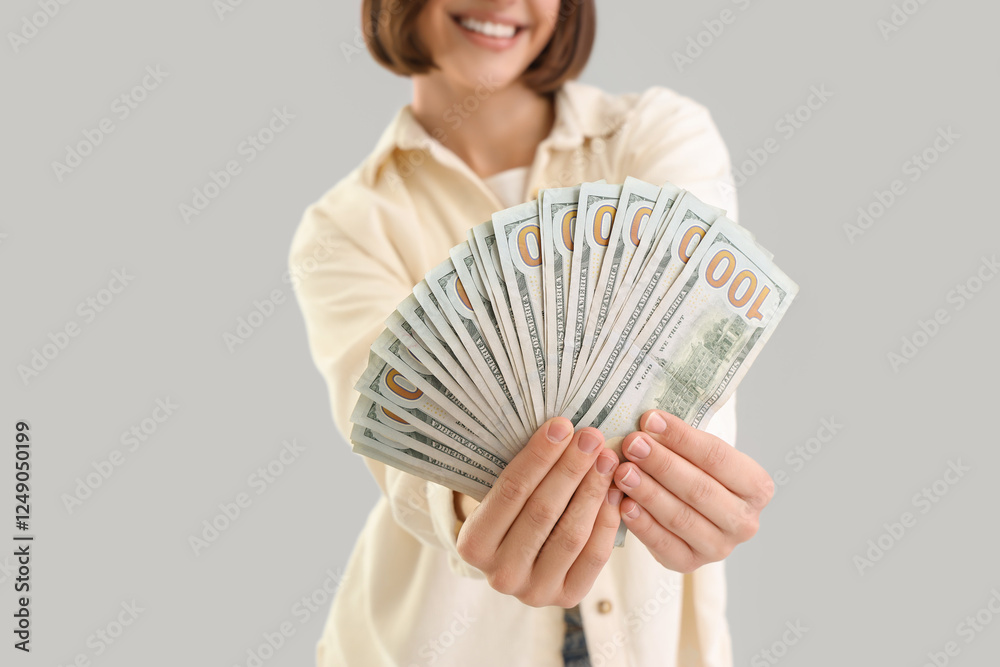 Young woman with dollar banknotes on light background, closeup Young woman with dollar banknotes on light background, closeup