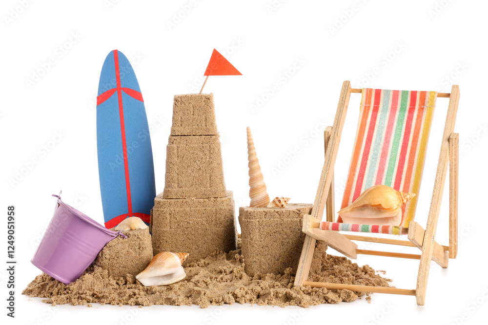 Castle made of sand, seashells, mini deckchair, surfboard and bucket on white background Castle made of sand, seashells, mini deckchair, surfboard and bucket on white background