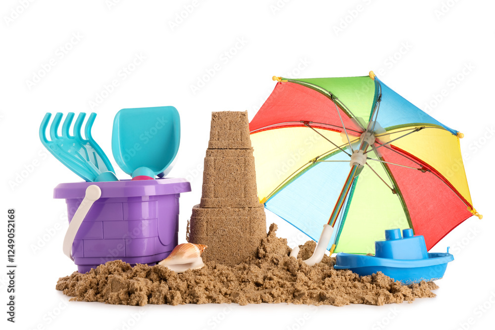 Castle made of sand, beach toys and small umbrella on white background