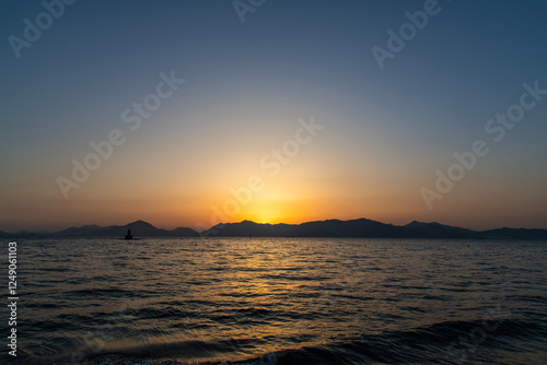 View of the sunset over the sea and island