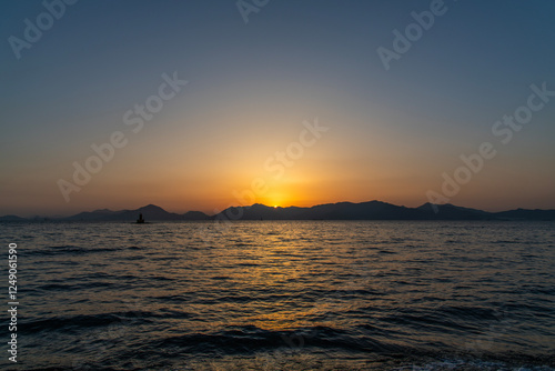 View of the sunset over the sea and island