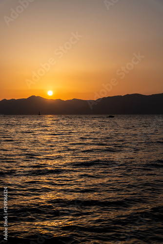 View of the sunset over the sea and island