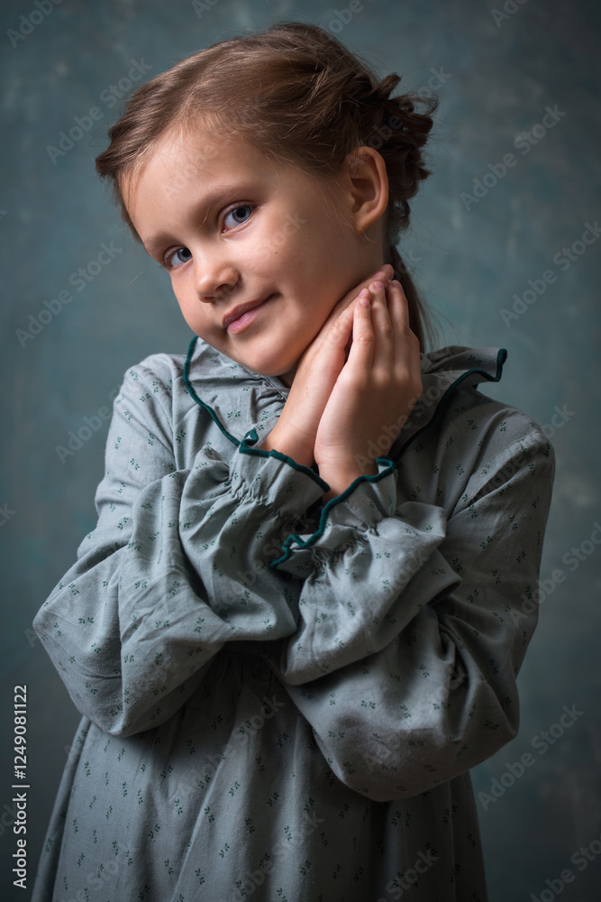 Beautiful cute little girl in a vintage gray dress
