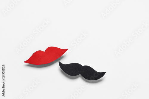 Male mustache and female lips made of paper isolated on white background