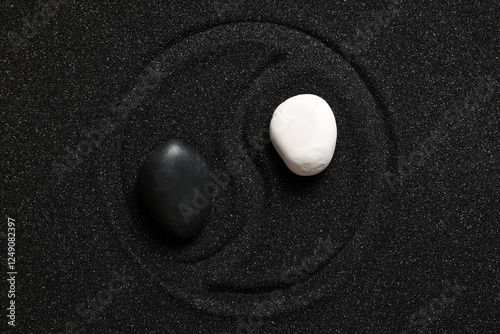 Photography Yin yang symbol with black and white stones on black sand, balance and harmony c