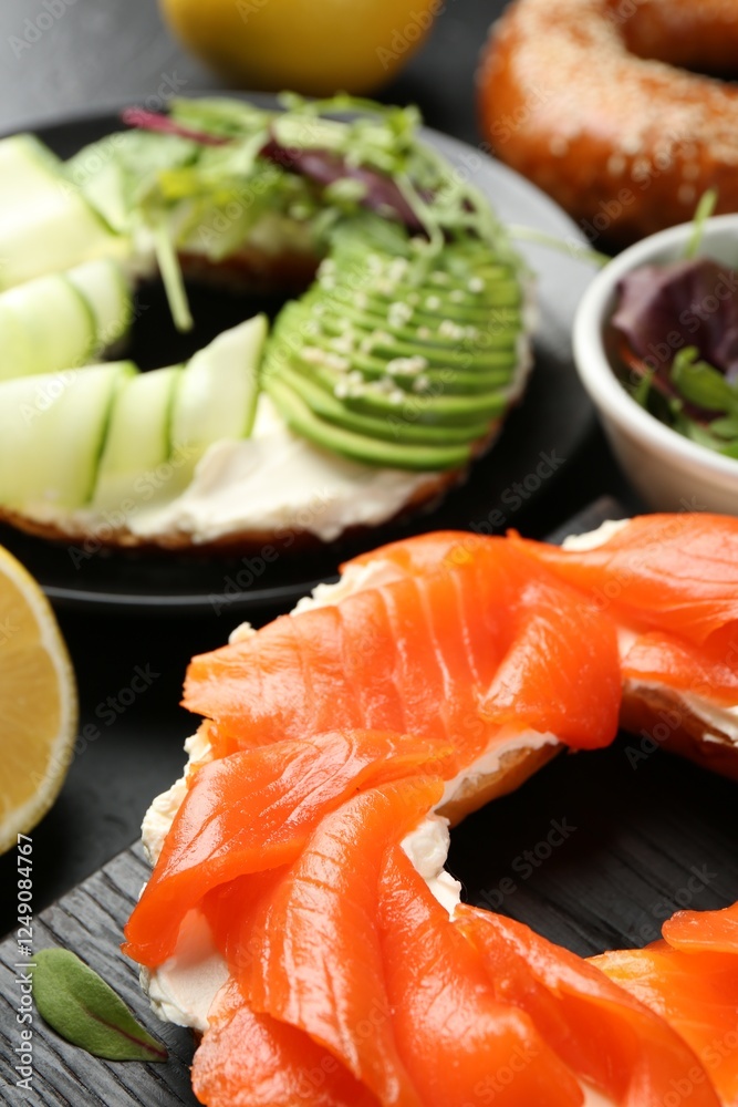 Delicious bagels with salmon and vegetables on black table, selective focus Delicious bagels with salmon and vegetables on black table, selective focus