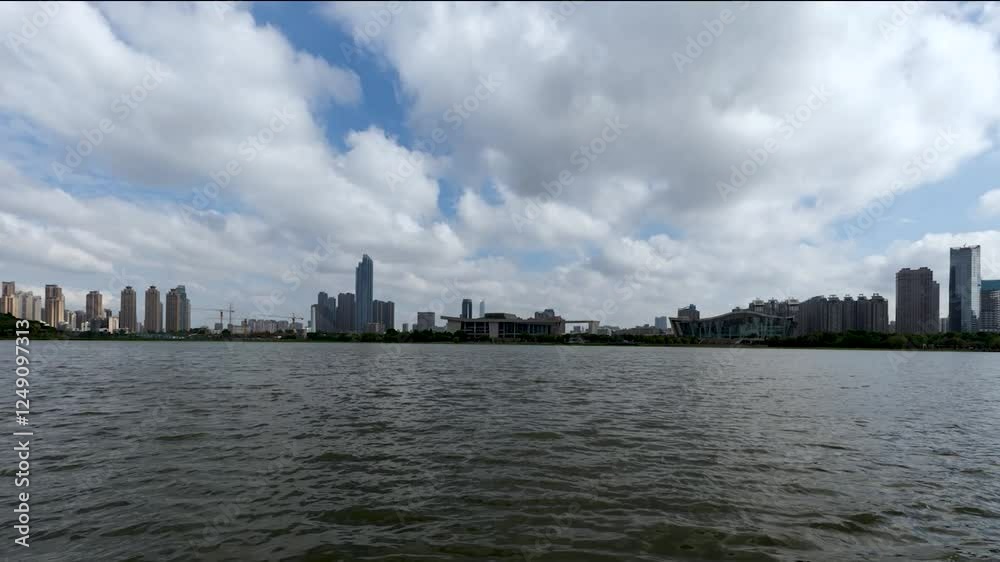 Explore the beauty of Wuhan's Qintai Park with stunning blue skies and white clouds in a dynamic time lapse setting Explore the beauty of Wuhan's Qintai Park with stunning blue skies and white clouds in a dynamic time lapse setting
