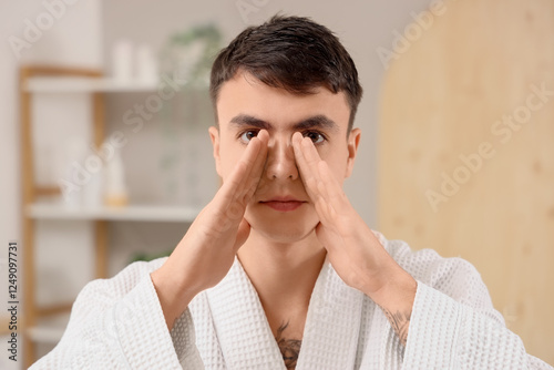 Young man doing face buildi...