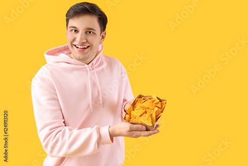 Young man with tasty nachos...