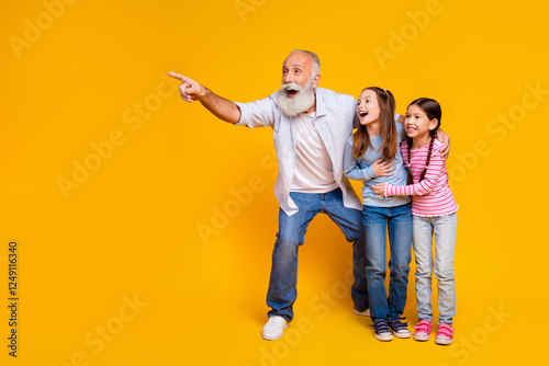 Grandfather Enjoying Bonding Time with Excited Grandchildren on Vibrant Yellow Background